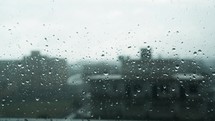 Rainy Day In The Blurred City Over Window