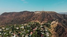 drone is flying by hollywood sign