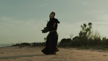 Monk Does Jump Rope On The Beach