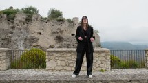 Young Woman Dressed In Black Dances On Bricks