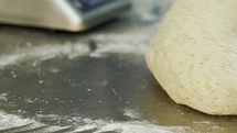 Close up on chef hands while preparing dough for pita bread