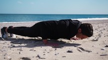 Boy Does Push Up Exercises In Outdoor Gym On The Beach Near The Sea