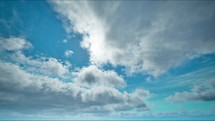 Timelapse of sun on the blue sky with moving clouds. Day with cloudy sky. Beautiful cloudscape 