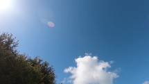 Moving clouds on a blue sky. Time lapse on a bright day