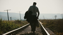 "A lonely man walking along railroad.
The clip can illustrate return home from war or prison.
Europe between 1940-1960."
