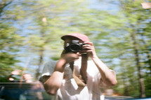 blurry image of a man holding a camera 