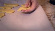 a child cutting out Christmas cookies 