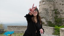 Smiling Women With Eyeglasses Makes Victory Symbol With Hands