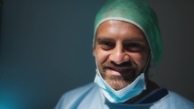 Italian Surgeon lowers the mask and smiles
