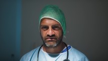 Italian man Doctor smile with lab coat and stethoscope in surgical room