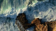 Waves crashing into majestic rocks 