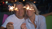 Couple with lit sparklers