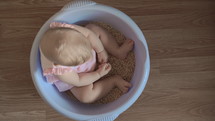 Cute baby girl in a round blue tub 1