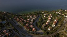 Flying over town on waterfront and blue sea