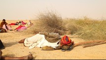 nomads sleeping on the desert sand 