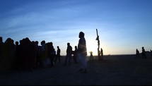 men and women gathering at sunset in India 