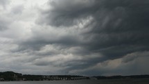gray clouds moving over a lake