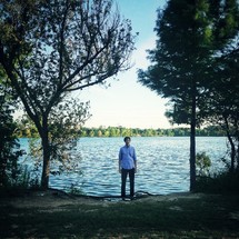 Man standing in front of a lake