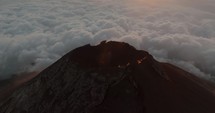 Stunning View Of Sun Setting On The Horizon Lighting The Fuego Volcano With Sun Rays In Antigua, Guatemala. aerial