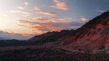 Timelapse of scenic orange clouds moving over mountains in Death Valley national park