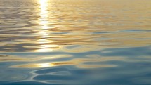Rippling water with sunset reflection