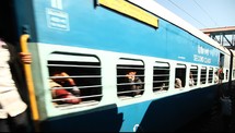 people on a passing train in India 