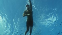 Man swim in the open ocean during summer