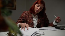 Business woman searches papers among her notes