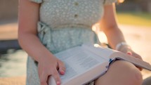 Girl Reading Bible Outside at Sunset