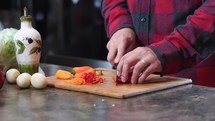 a man chopping peppers 