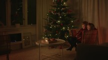 Children Reading the Bible by the Christmas Tree