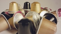 Macro shot of espresso capsules in various colors and flavors