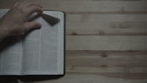 man turns to Acts in the Bible 