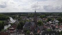 Circling aerial view of a church and tower in a Dutch village Loenen, Netherlands