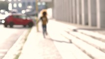 a woman running on a city sidewalk 