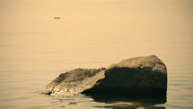 Sea of Galilee in the early morning, ripples on the water and boat. Israel.
