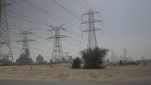 Electrical power lines in the middle eastern desert outside of Dubai, United Arab Emirates.