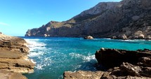 Waves hitting rocks on the coast of Mallorca, sunny day, in Balearic islands, Spain