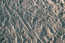 multiple footprints in the sand 