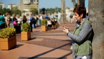 a woman scrolling through her cellphone 