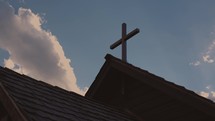 Cross against a partly cloudy sky