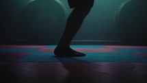 Legs of male boxer with skipping rope