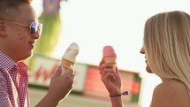 a couple eating ice cream cones on a date 
