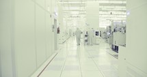 Workers in clean suits in a Semiconductor manufacturing facility