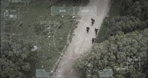 Military surveillance drone view of terrorists walking through a forest