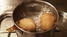 boiling eggs in a water filled pot