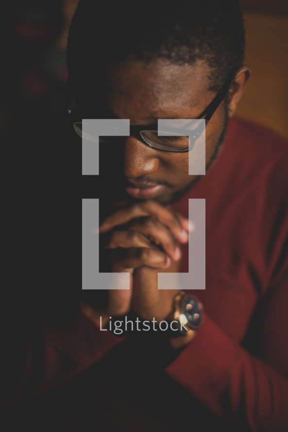African American, man, reading glasses, head bowed, praying hands, prayer 