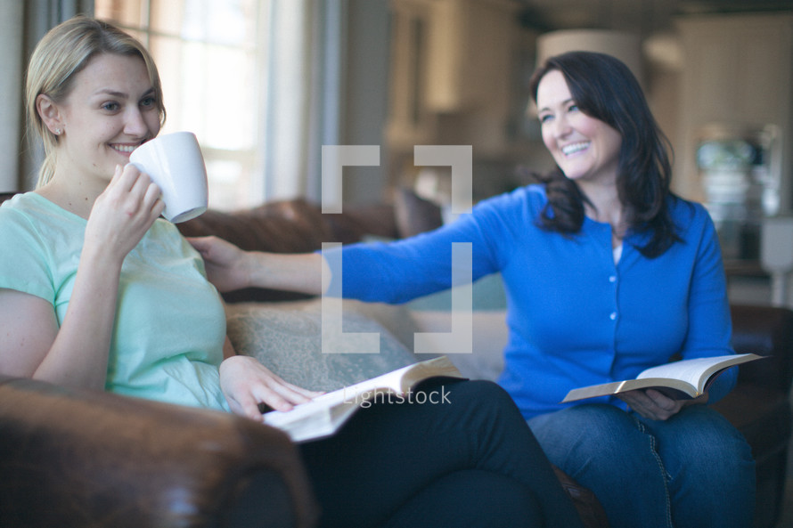 Smiling women drinking coffee during a Bible study.