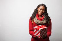 Woman holding a wrapped Christmas gift. 