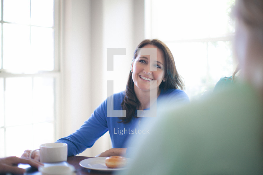 Smiling woman at the breakfast table.